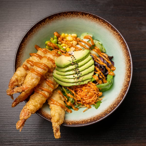 A Sushi Alive poke bowl with crispy tempura shrimp, avocado, corn, edamame, and carrots.